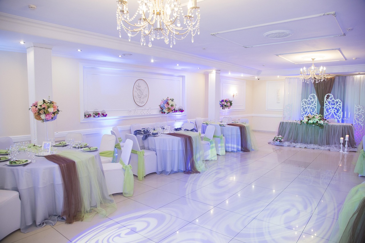 Warmly lit banquet hall set with tables and chairs